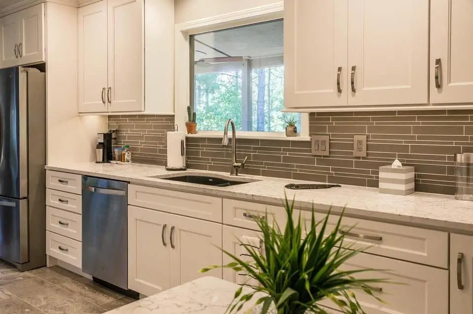 Modern open concept kitchen with a large island and quartz countertops.